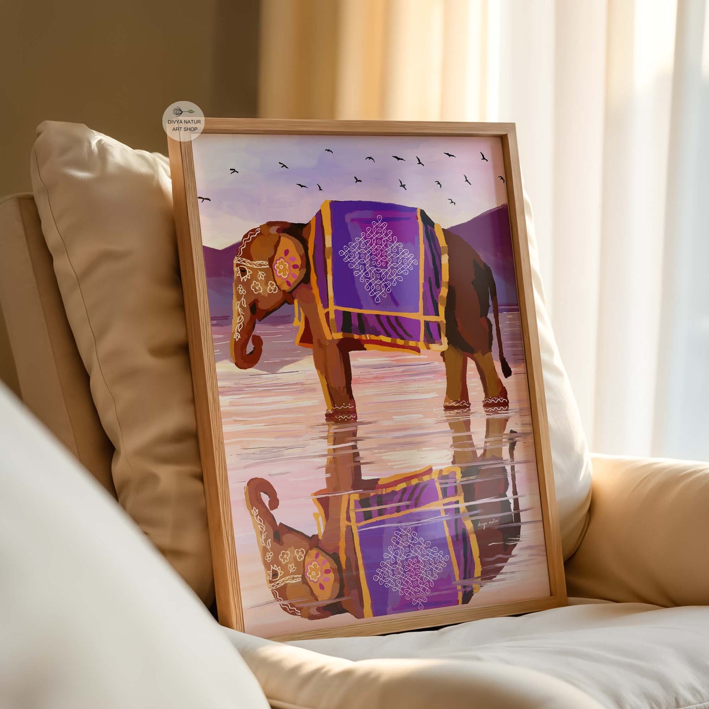 Framed artwork of an elephant with a purple blanket on a couch