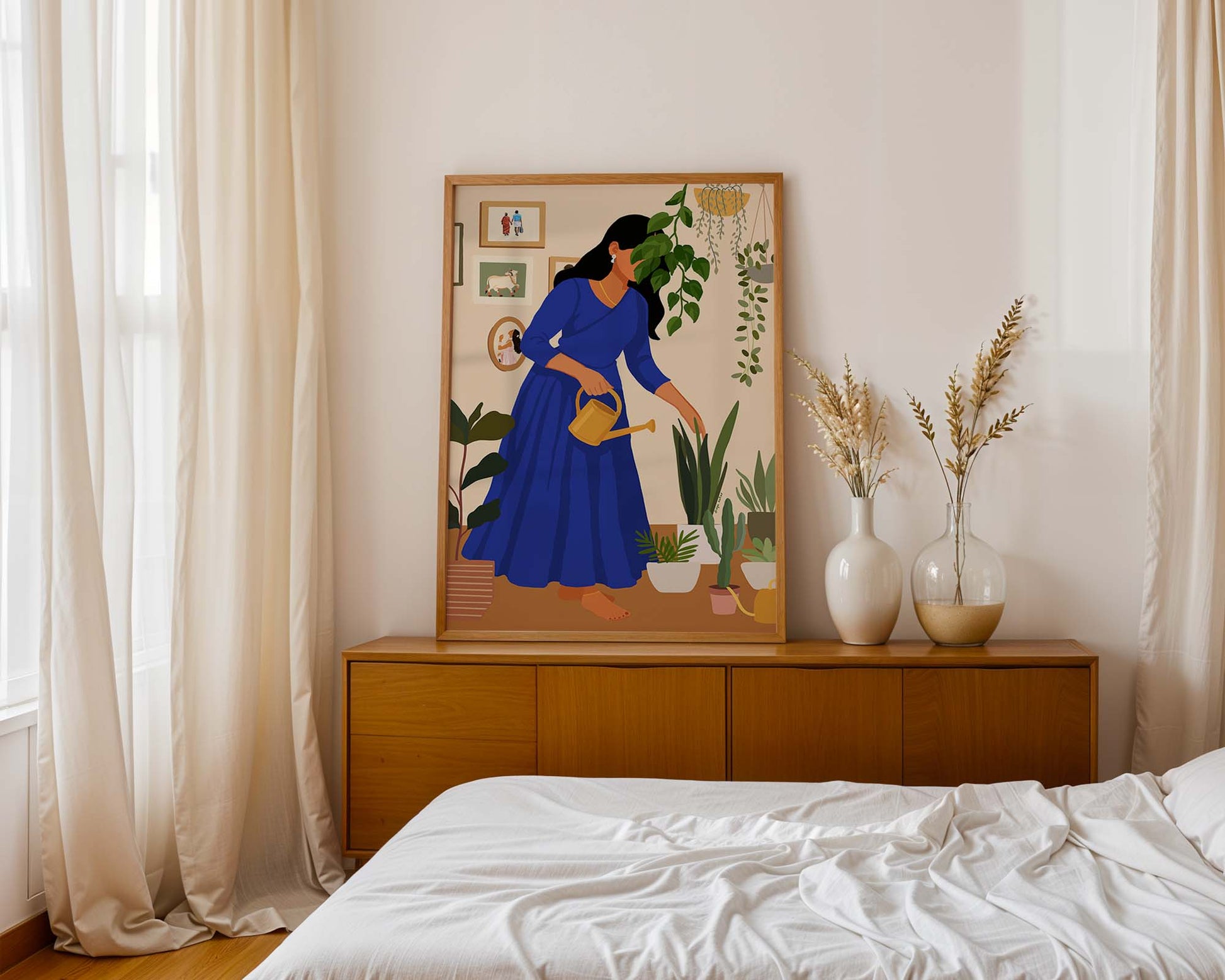 Bohemian wall art of woman in blue watering lush potted plants indoors