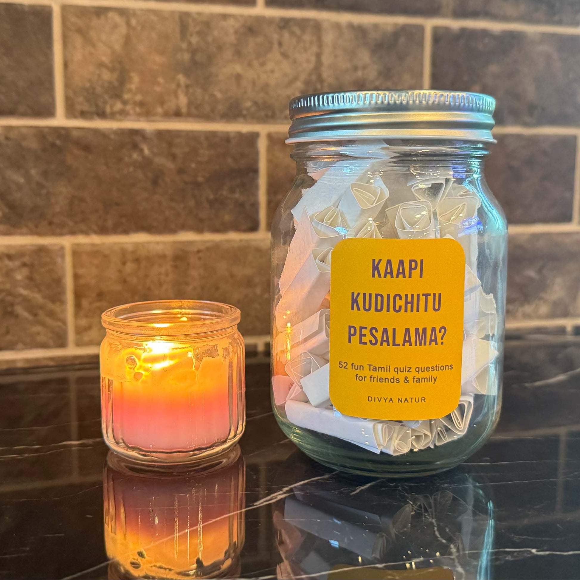 Tamil trivia question jar with quiz chits for testing knowledge about Tamil culture