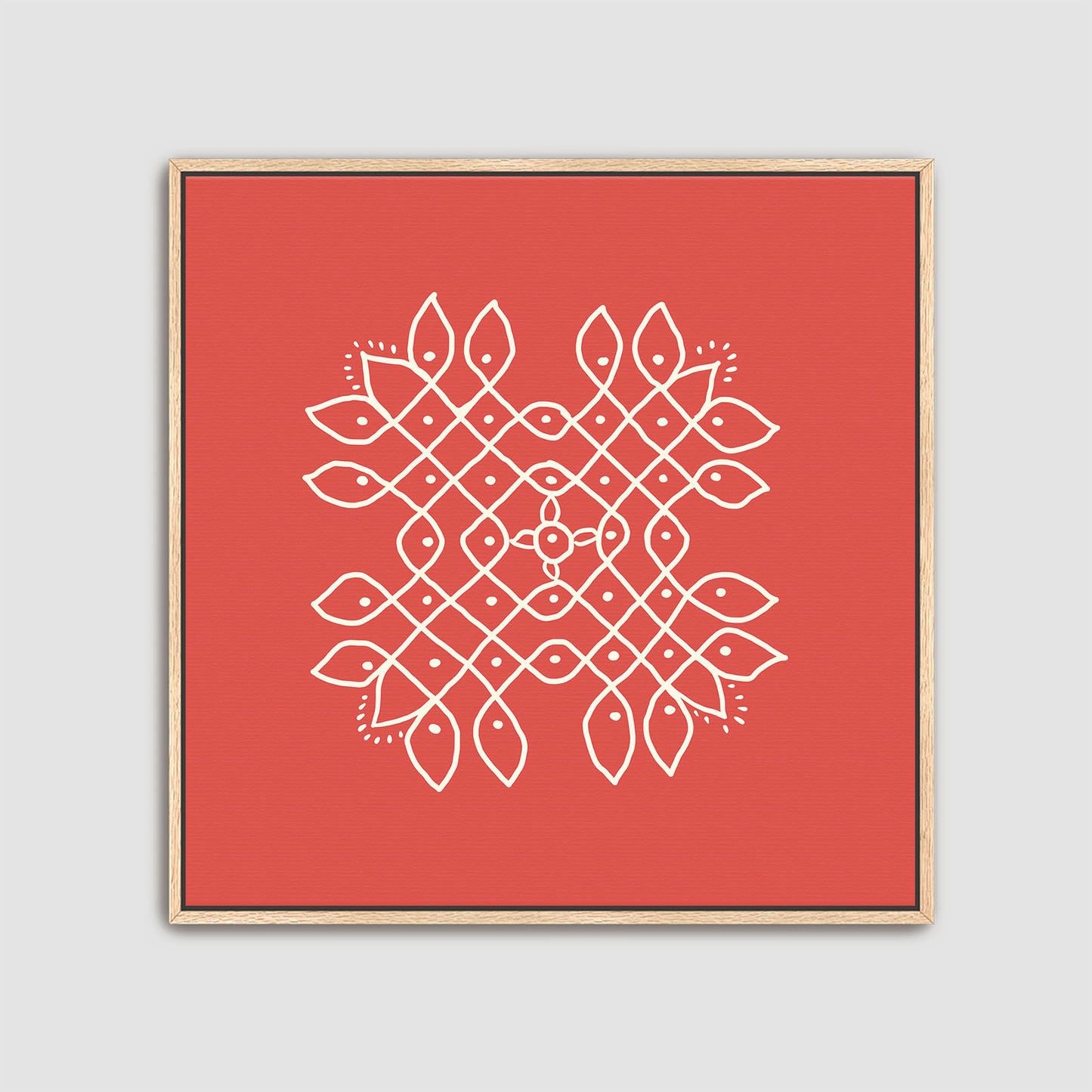 Framed artwork with a white kolam geometric pattern on a red background