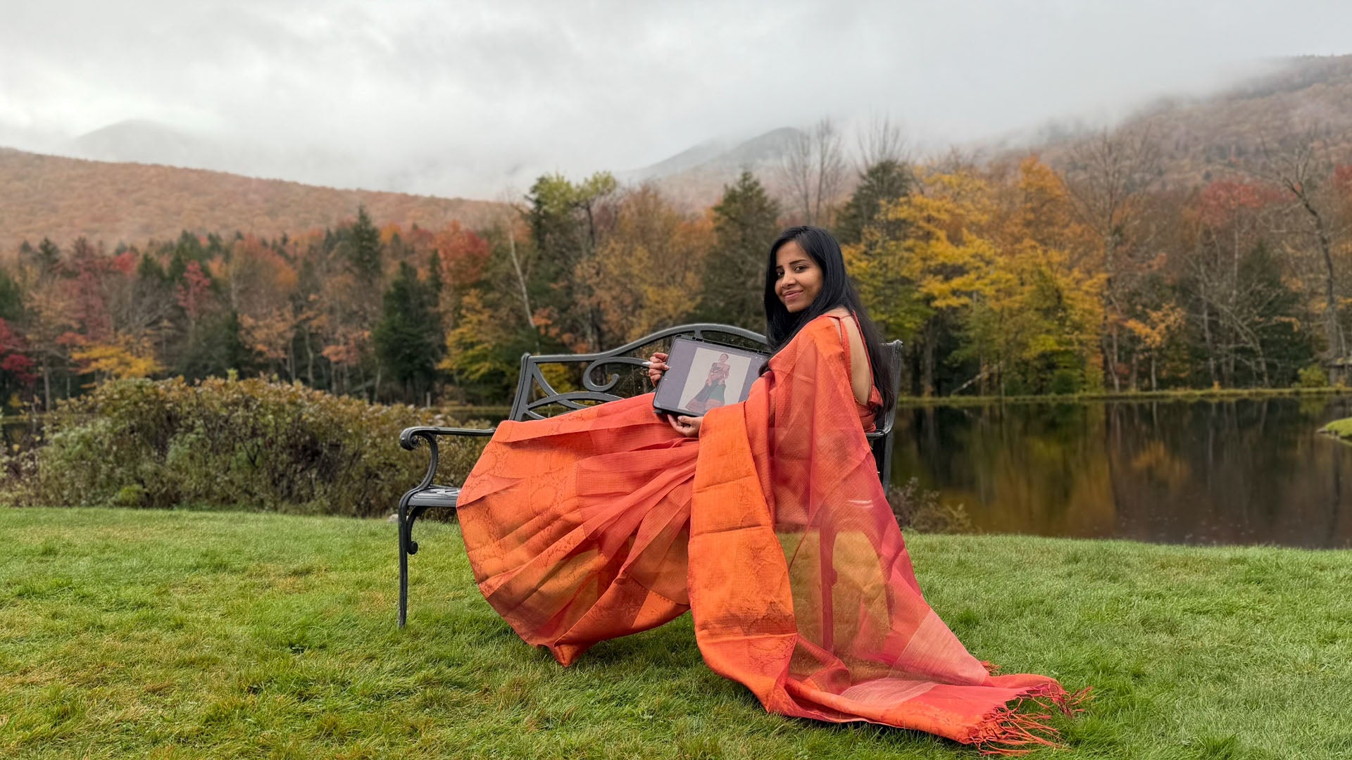 Load video: Divya Natur founder Divya Mani in a saree holding her artwork, introducing vibrant Indian art prints inspired by temples, culture, and food.