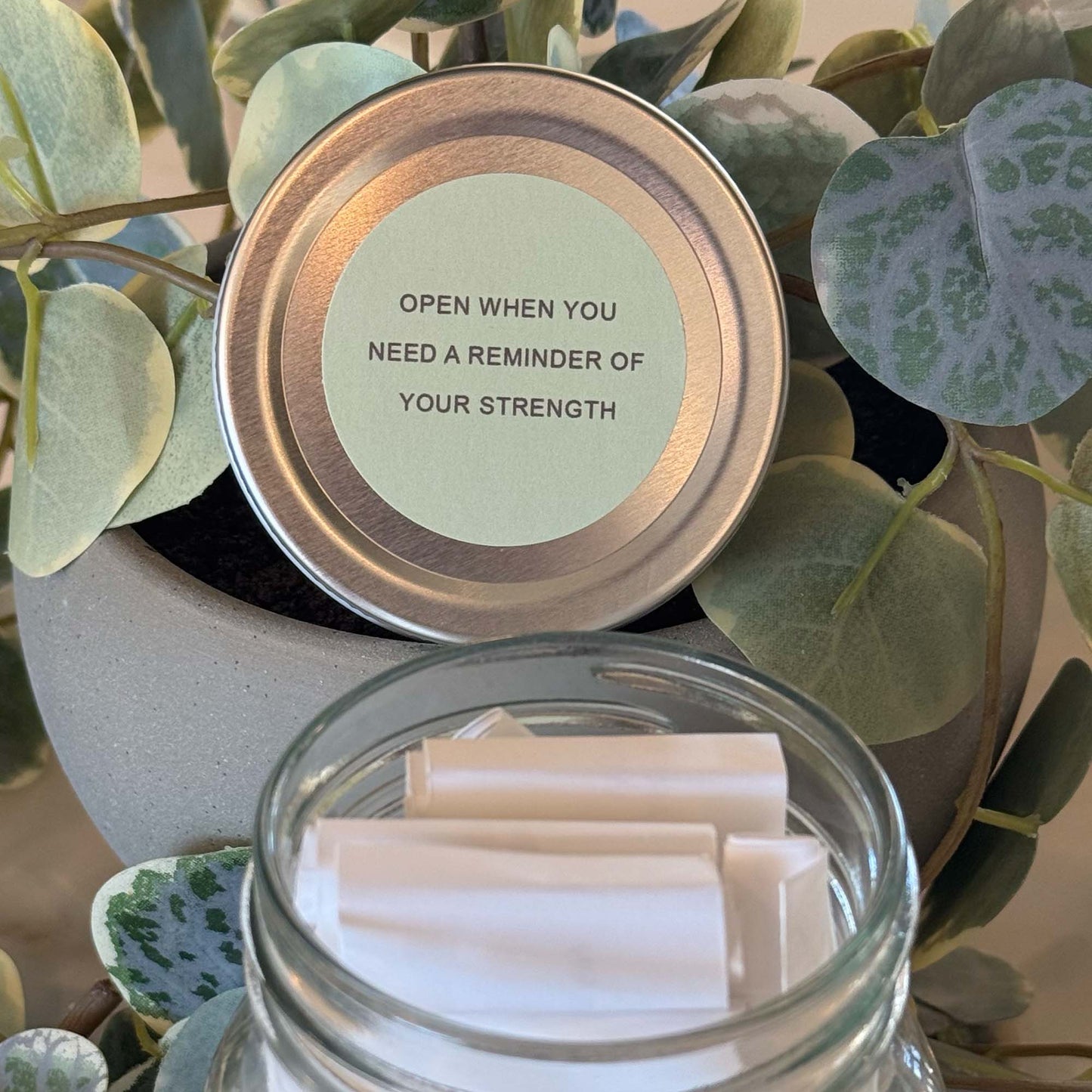 Glass affirmation jar with empowering messages designed to inspire women