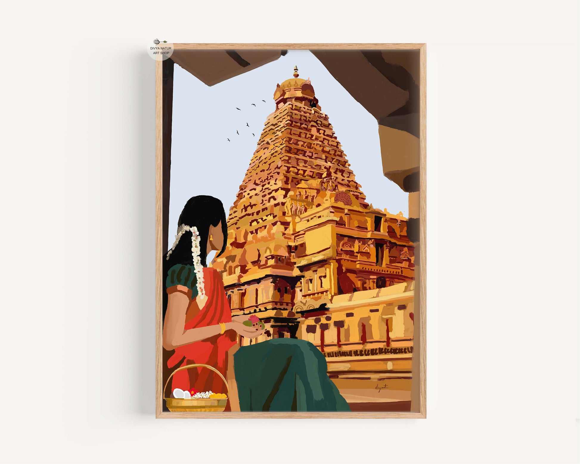Framed artwork of a South Indian woman sitting in front of a Tanjavur big temple