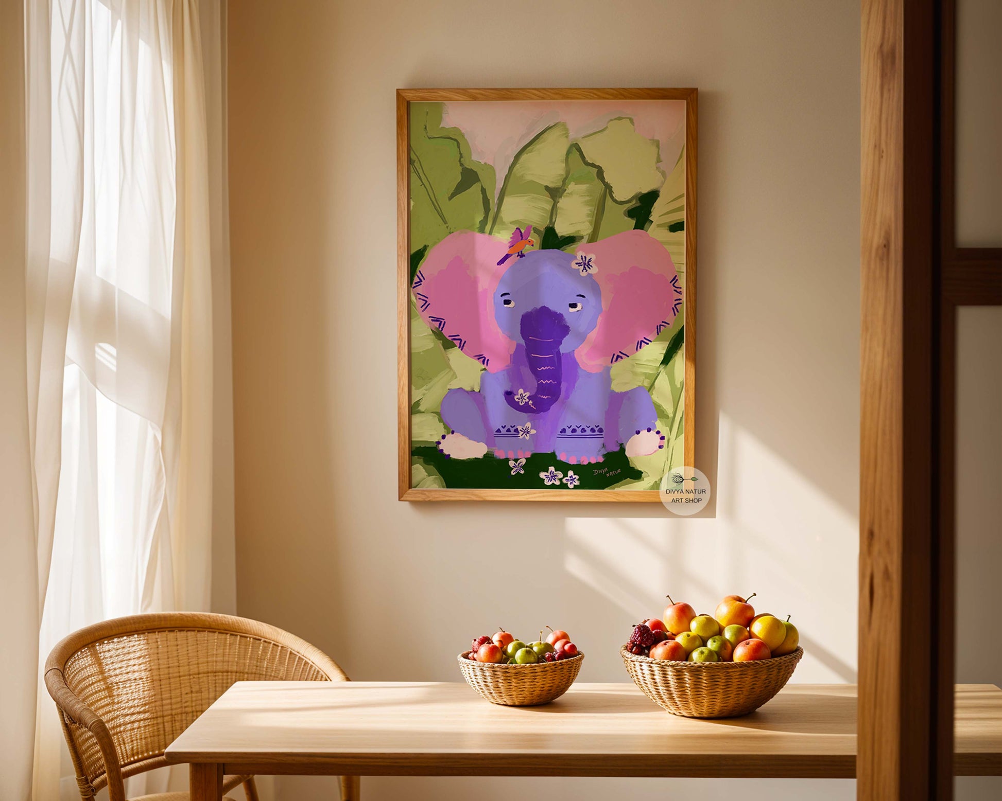 Framed children's artwork of an elephant on a wall above a table with fruit bowls.